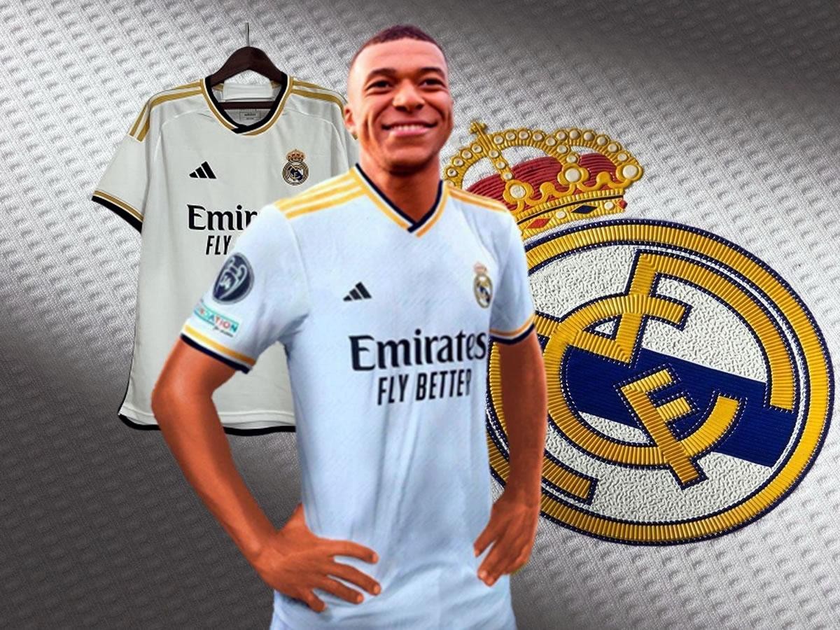  Kylian Mbappe is pictured wearing a Real Madrid jersey with a big smile on his face.